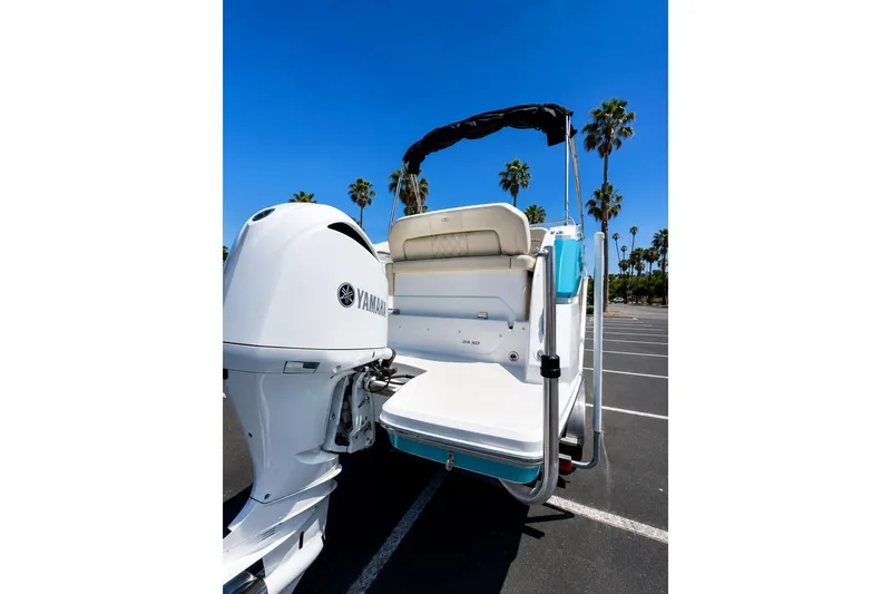 Slide: The Image of 2019 Regal 26 XO boat with Yamaha engine, parked under clear blue sky. - 4