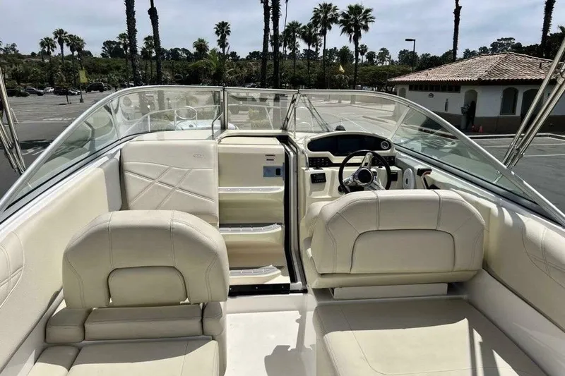 Slide: The Image of 2019 Regal 26 XO boat interior with beige seating and steering console. - 7
