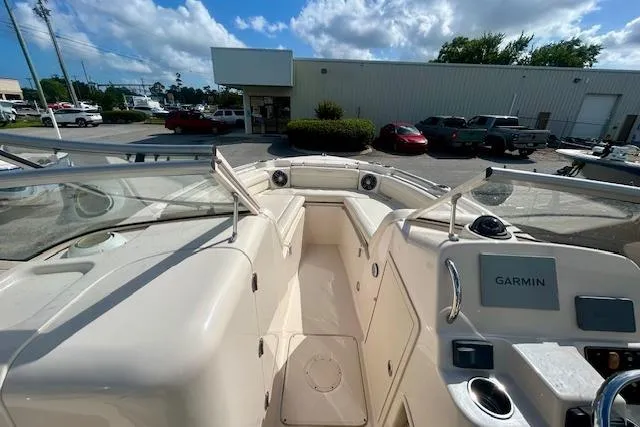 Slide: The Image of 2022 Grady-White Freedom 215 boat interior with Garmin navigation, parked outdoors. - 10