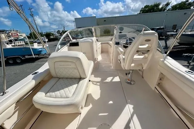 Slide: The Image of 2022 Grady-White Freedom 215 boat interior with plush seating and steering console. - 16