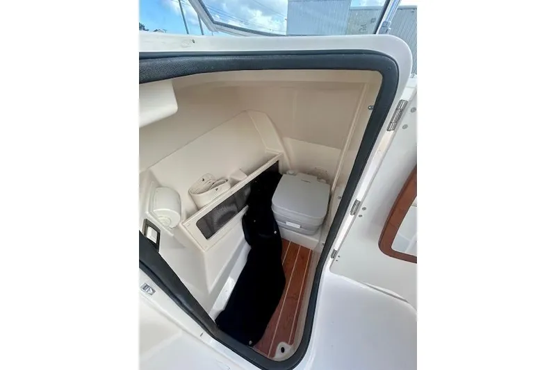Slide: The Image of 2022 Grady-White Freedom 215 boat interior with compact storage and portable toilet. - 6