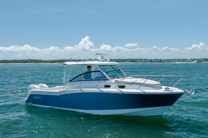 The Image of 2017 Boston Whaler 315 Conquest boat cruising on open water under clear skies. - 0