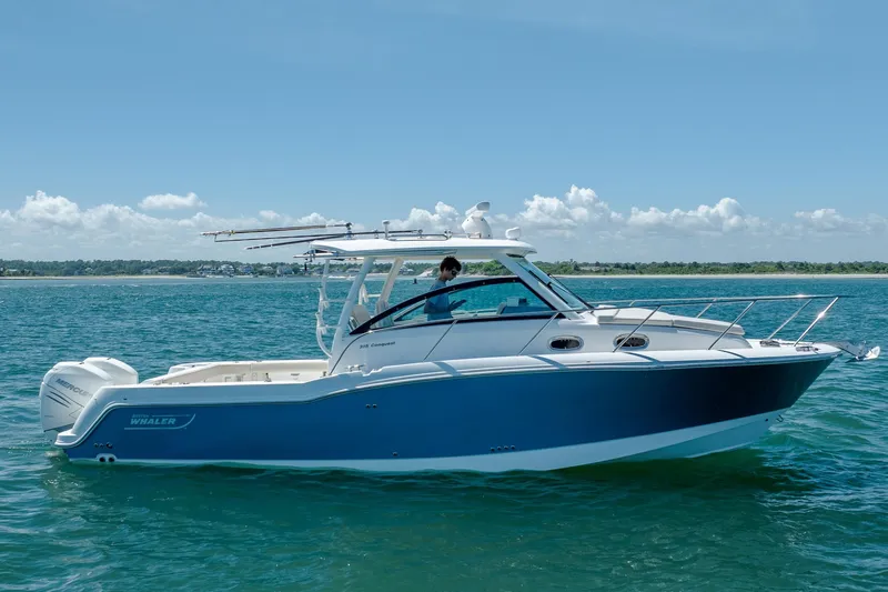 Slide: The Image of 2017 Boston Whaler 315 Conquest boat on clear blue water under a sunny sky. - 1