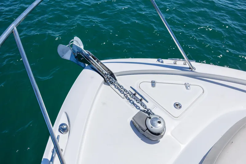 Slide: The Image of Bow of 2017 Boston Whaler 315 Conquest with anchor and chain on blue water. - 11
