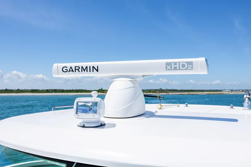 Slide: The Image of Garmin xHD2 radar on 2017 Boston Whaler 315 Conquest boat under clear blue sky. - 13