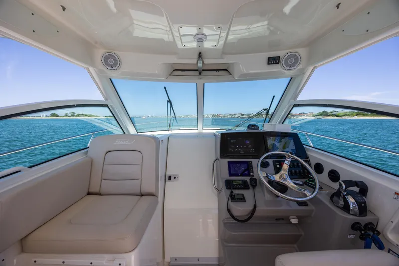 Slide: The Image of Interior view of 2017 Boston Whaler 315 Conquest boat cockpit with steering wheel and navigation equipment. - 21