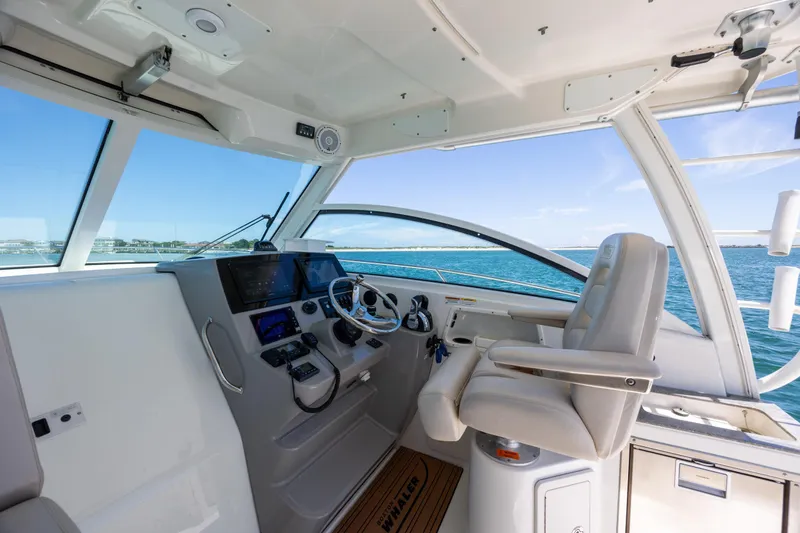 Slide: The Image of Helm of 2017 Boston Whaler 315 Conquest with ocean view and modern controls. - 23