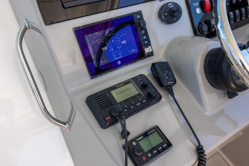 Slide: The Image of Control panel of a 2017 Boston Whaler 315 Conquest with navigation and communication equipment. - 25