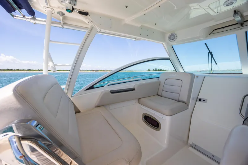 Slide: The Image of 2017 Boston Whaler 315 Conquest interior with comfortable seating and ocean view. - 28