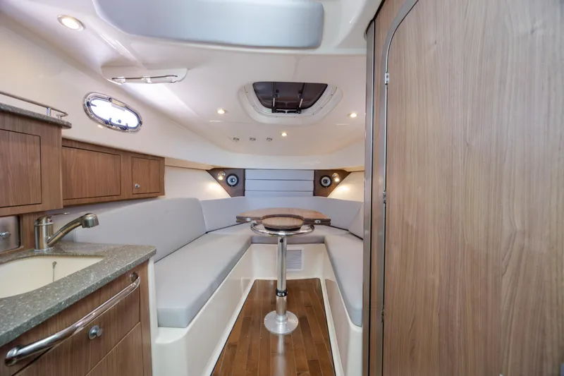 Slide: The Image of Interior of 2017 Boston Whaler 315 Conquest boat with seating and kitchenette. - 29