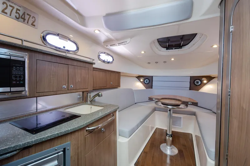 Slide: The Image of Interior of 2017 Boston Whaler 315 Conquest, featuring modern kitchen and cozy seating area. - 30