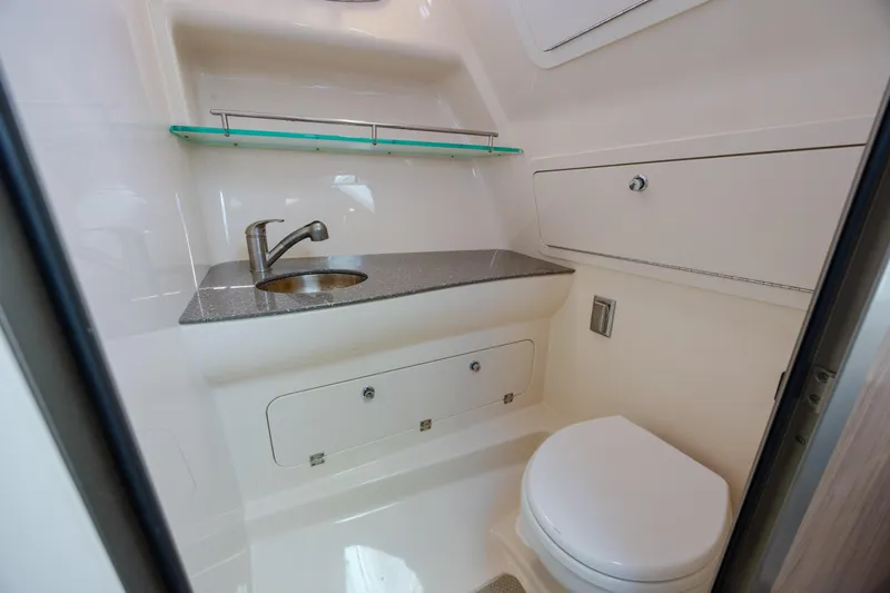 Slide: The Image of 2017 Boston Whaler 315 Conquest bathroom with sink, toilet, and storage. - 34
