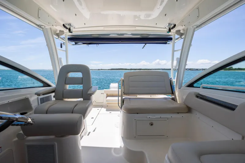 Slide: The Image of Interior view of 2017 Boston Whaler 315 Conquest boat with seating and ocean backdrop. - 39