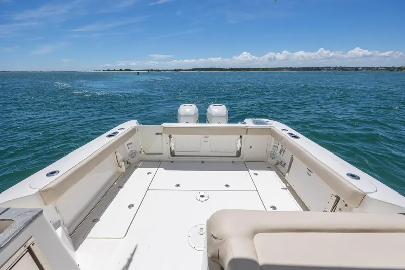 Slide: The Image of 2017 Boston Whaler 315 Conquest boat deck with ocean view and clear blue sky. - 40