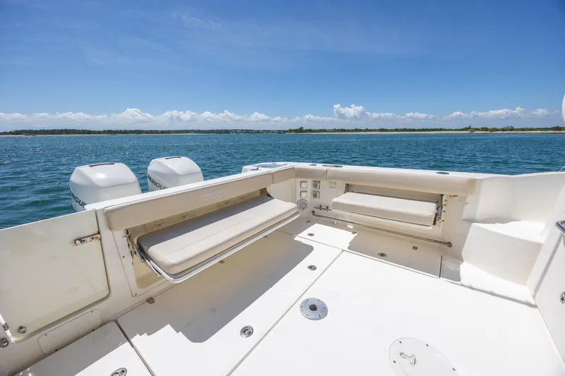 Slide: The Image of 2017 Boston Whaler 315 Conquest boat deck with seating, overlooking serene blue waters. - 41