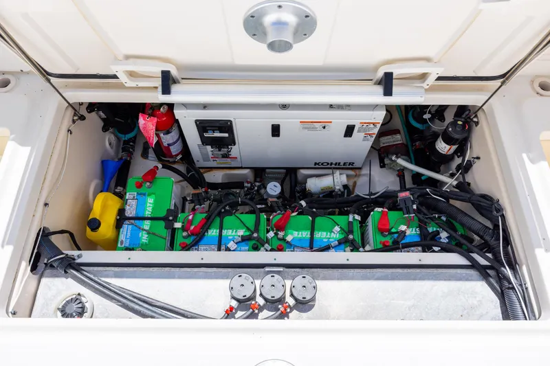 Slide: The Image of Engine compartment of 2017 Boston Whaler 315 Conquest with batteries and equipment. - 43