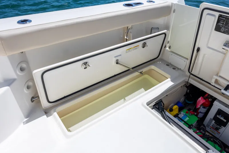 Slide: The Image of 2017 Boston Whaler 315 Conquest boat storage compartments and equipment access. - 44