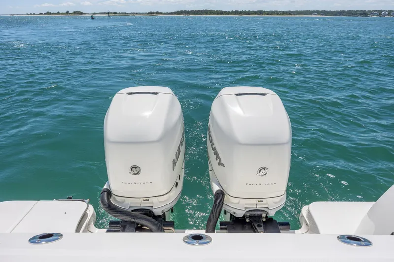 Slide: The Image of Twin Mercury outboard engines on a 2017 Boston Whaler 315 Conquest in open water. - 45