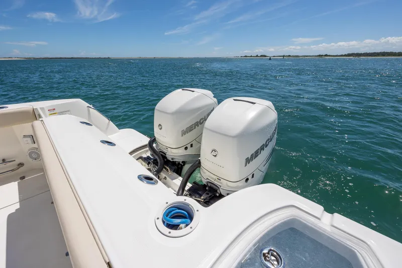 Slide: The Image of 2017 Boston Whaler 315 Conquest with dual Mercury outboard engines on open water. - 46
