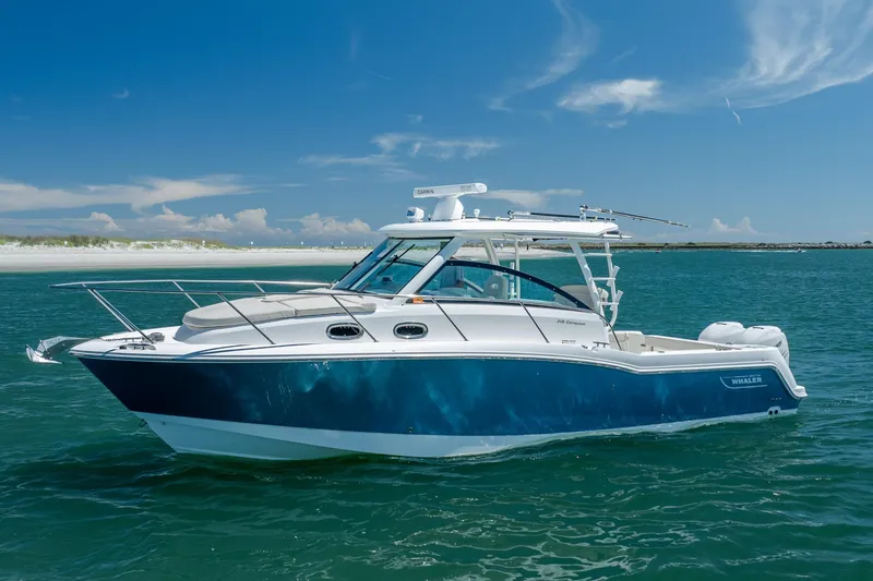 Slide: The Image of 2017 Boston Whaler 315 Conquest boat on clear blue water under a sunny sky. - 6