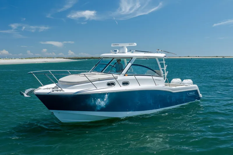Slide: The Image of 2017 Boston Whaler 315 Conquest boat cruising on clear blue water. - 7