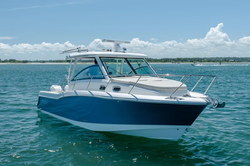 Slide: The Image of 2017 Boston Whaler 315 Conquest boat on open water under clear sky. - 9