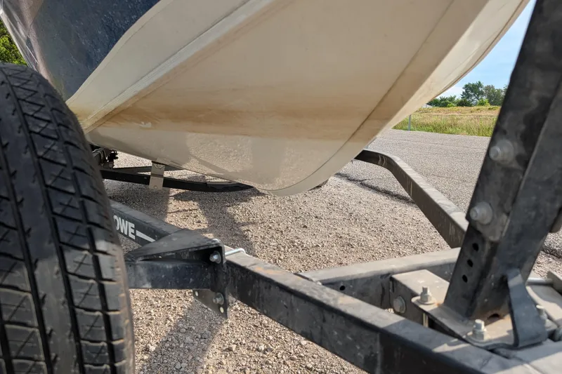 Slide: The Image of 2017 Lowe Fishing Machine 165SC Pro on trailer, close-up view of hull and tire. - 10