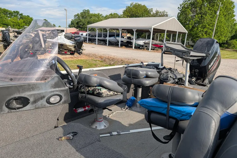 Slide: The Image of 2017 Lowe Fishing Machine 165SC Pro boat interior with seats and Mercury engine. - 14
