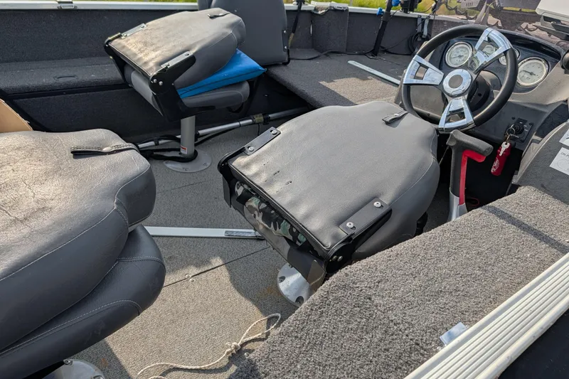 Slide: The Image of 2017 Lowe Fishing Machine 165SC Pro interior with steering wheel and seating. - 17