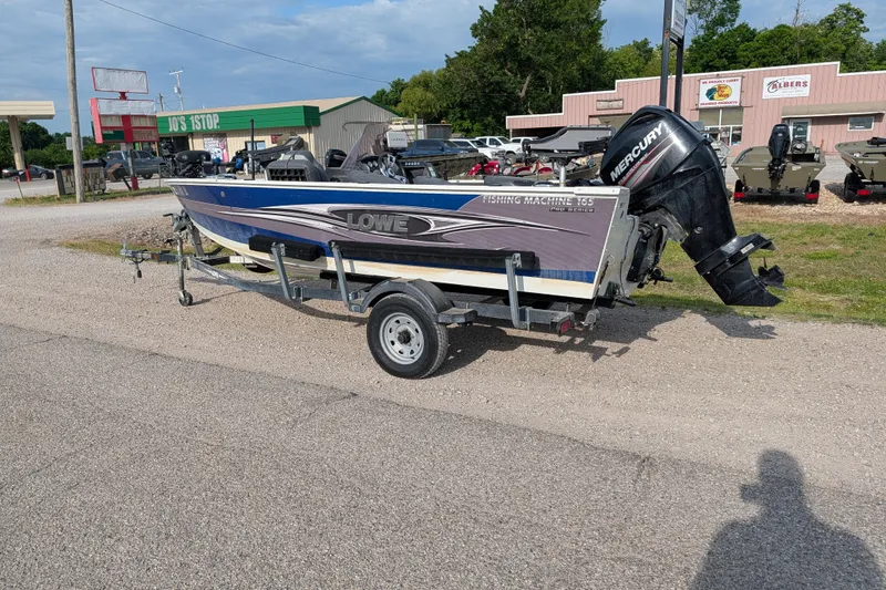 Slide: The Image of 2017 Lowe Fishing Machine 165SC Pro boat on trailer, parked outdoors. - 3