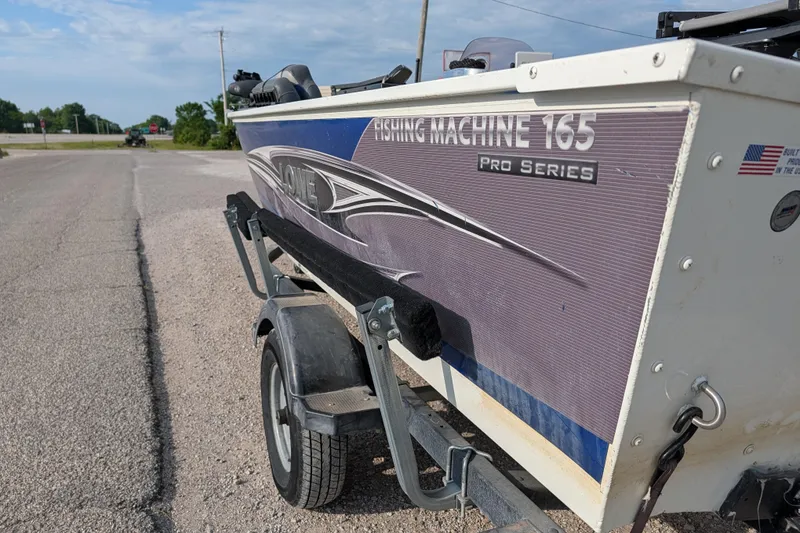 Slide: The Image of 2017 Lowe Fishing Machine 165SC Pro boat on trailer, roadside view. - 4