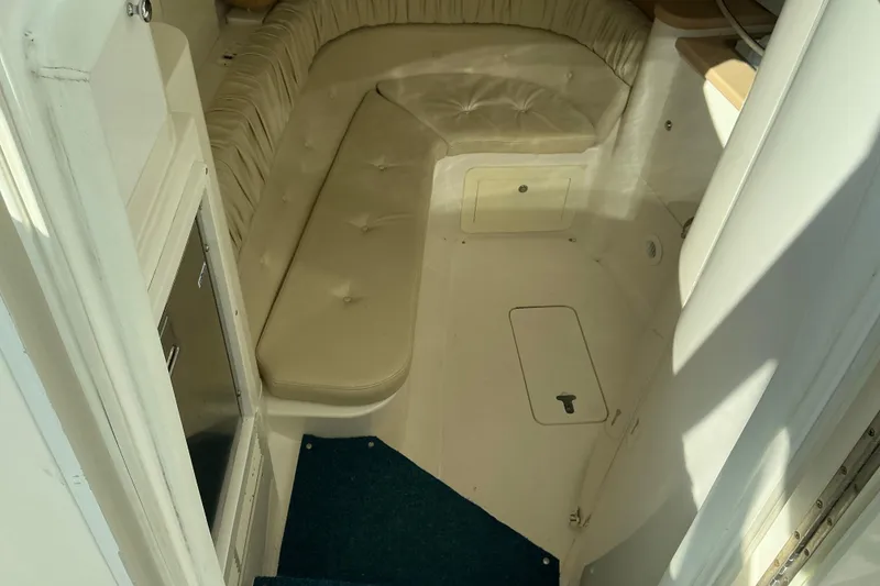 Slide: The Image of 2005 Intrepid 348 Walkaround cabin interior with beige seating and storage compartments. - 14