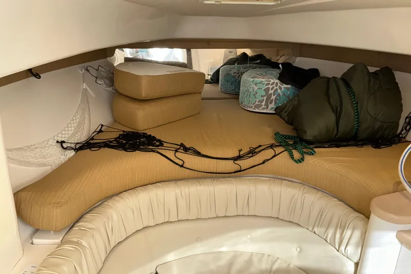 Slide: The Image of 2005 Intrepid 348 Walkaround cabin interior with cushions and storage. - 15