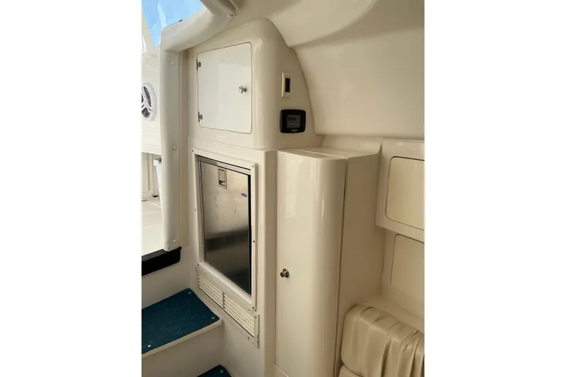 Slide: The Image of Interior view of a 2005 Intrepid 348 Walkaround boat, featuring storage compartments. - 17
