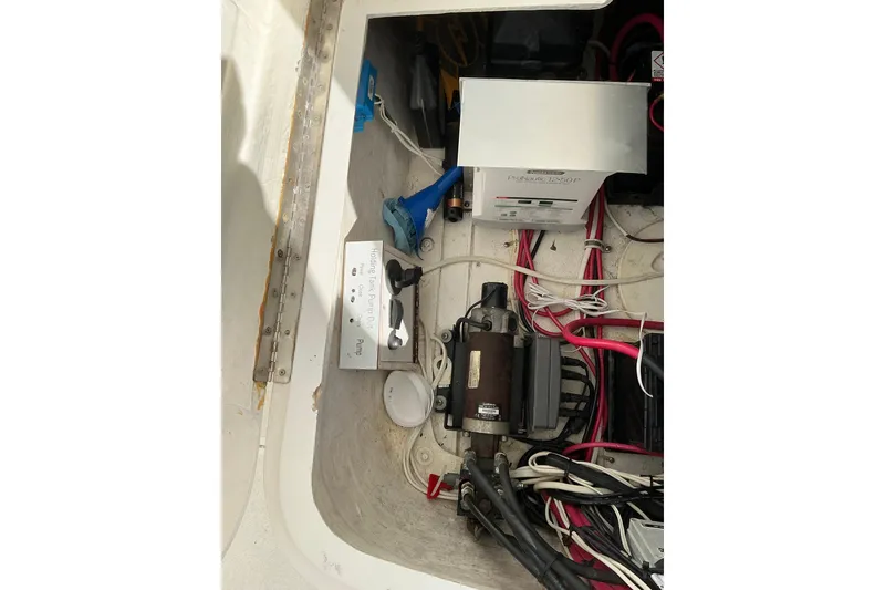 Slide: The Image of Electrical components and wiring inside a 2005 Intrepid 348 Walkaround boat compartment. - 21