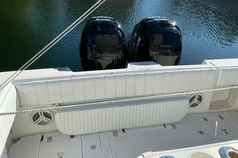 Slide: The Image of 2005 Intrepid 348 Walkaround boat with dual outboard engines on calm water. - 5