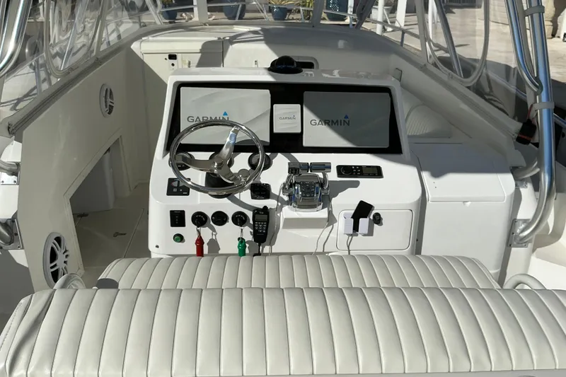 Slide: The Image of 2005 Intrepid 348 Walkaround boat helm with Garmin navigation system and white seating. - 6
