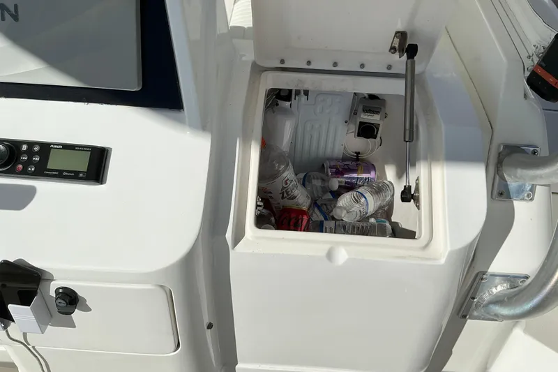 Slide: The Image of Open storage compartment on 2005 Intrepid 348 Walkaround boat with drinks and water bottles. - 7