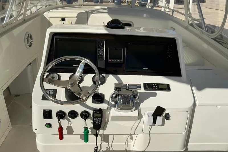 Slide: The Image of 2005 Intrepid 348 Walkaround boat dashboard with steering wheel and navigation controls. - 8