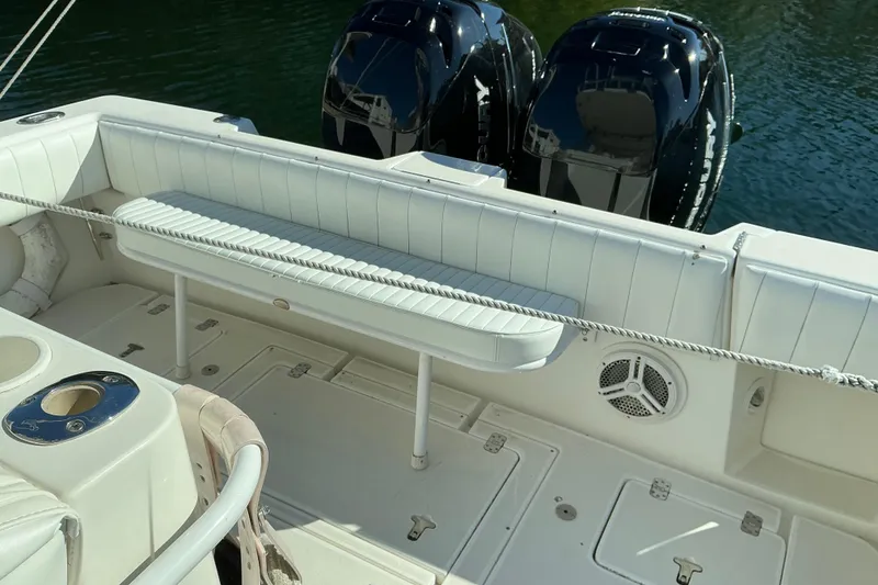 Slide: The Image of 2005 Intrepid 348 Walkaround boat interior with seating and dual outboard motors. - 9