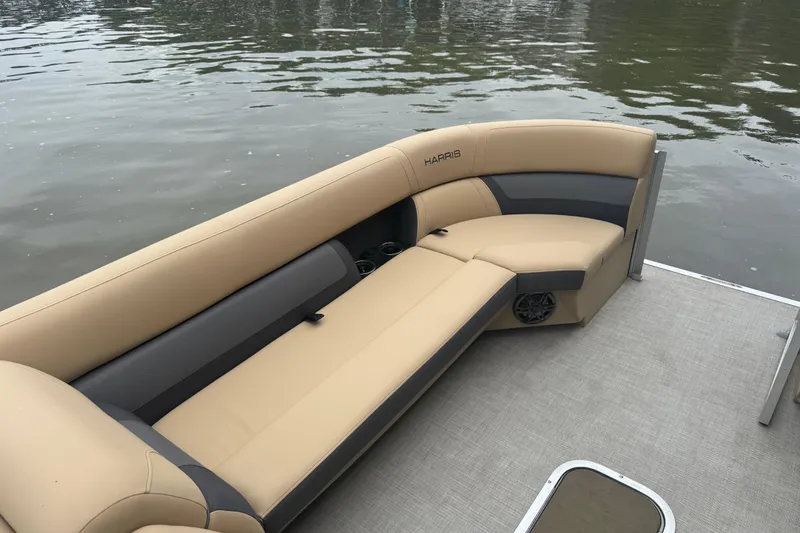 Slide: The Image of 2022 Harris Sunliner 250 pontoon boat with beige seating on calm water. - 17