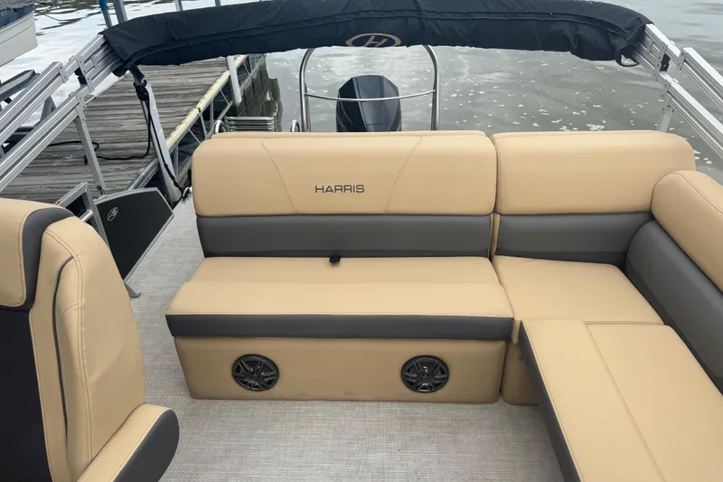 Slide: The Image of 2022 Harris Sunliner 250 boat interior with beige and gray seating. - 18
