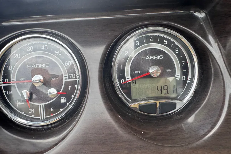 Slide: The Image of Dashboard of 2022 Harris Sunliner 250 showing speedometer and tachometer readings. - 23