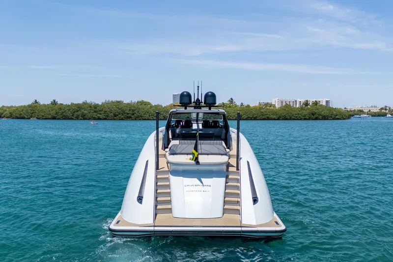 Slide: The Image of 2025 Wajer 77 yacht on blue water, rear view with lush greenery background. - 28