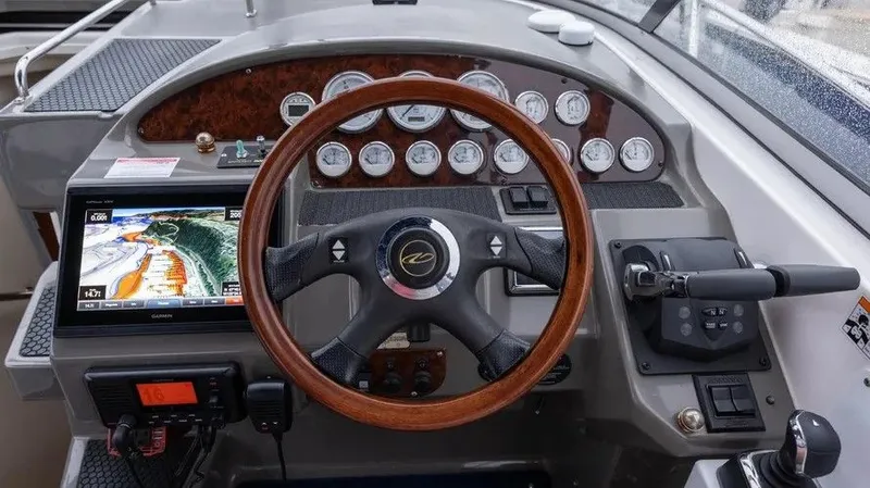 Slide: The Image of 2007 Regal 3360 Window Express helm with wood steering wheel and instruments. - 18