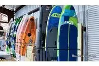 Slide: The Image of Various Hobie kayaks, model Mirage Passport 12.0 R, year 2023, in a storage area. - 5