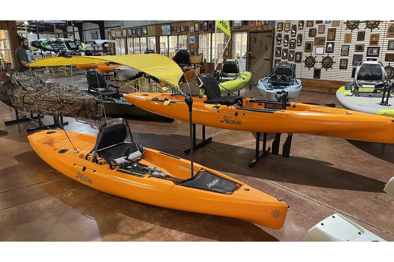 The Image of 2022 Hobie Mirage Compass kayaks displayed in a showroom. - 1