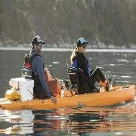 Slide: The Image of Two people in a Hobie Mirage Compass kayak on calm water. - 2