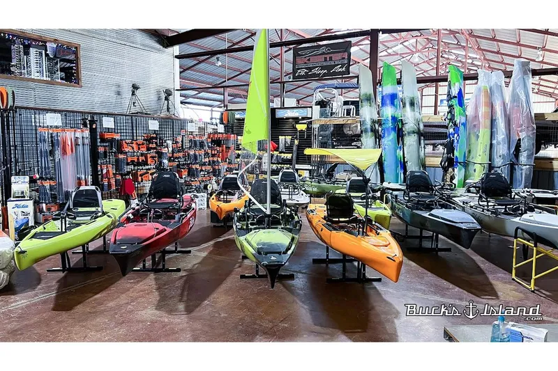 Slide: The Image of Hobie Mirage Compass 2022 kayaks displayed in a showroom. - 6