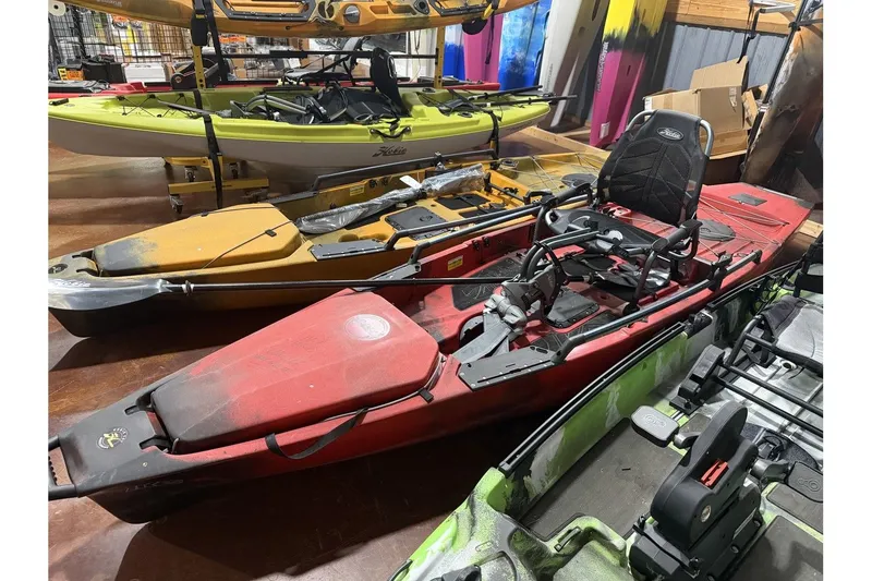 The Image of 2022 Hobie Mirage Pro Angler 14 kayak in red color in storage. - 1